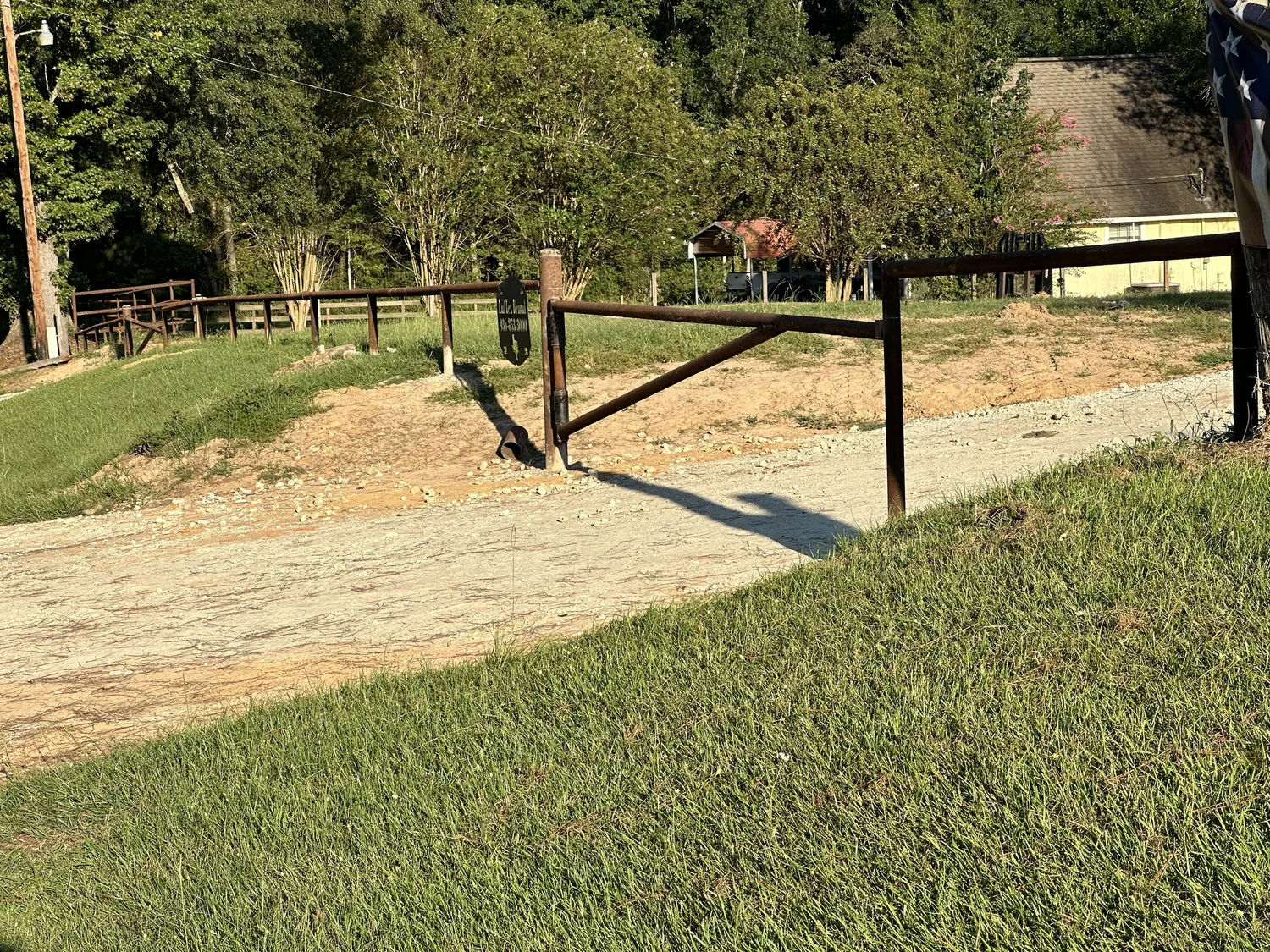 Metal fence and gate beside a rural property entrance